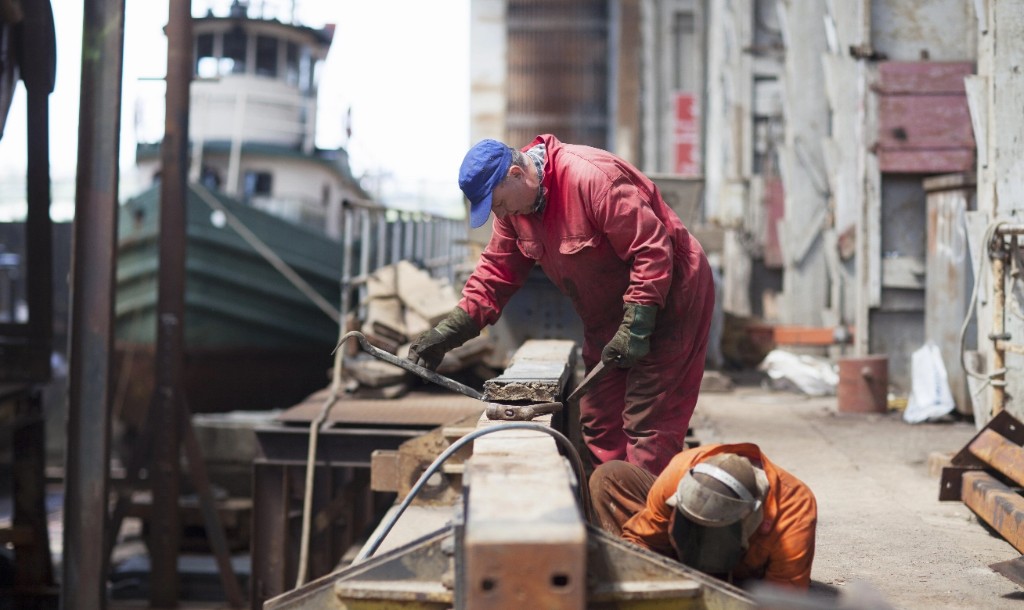 Tradespeople working in a marine shipyard
